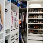 a walk in closet filled with lots of shoes