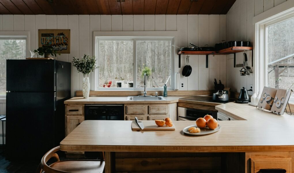 a kitchen with a table and a refrigerator