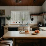 a kitchen with a table and a refrigerator