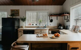 a kitchen with a table and a refrigerator
