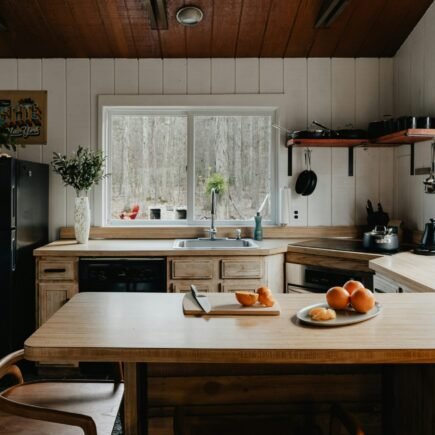 a kitchen with a table and a refrigerator