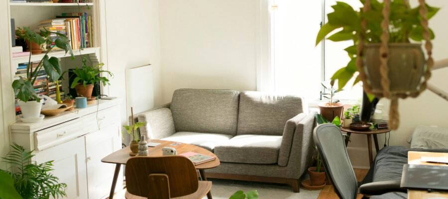 gray fabric loveseat near brown wooden table