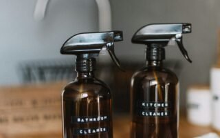 two brown spray bottles on brown table