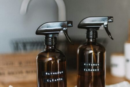 two brown spray bottles on brown table