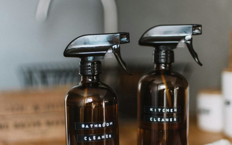 two brown spray bottles on brown table