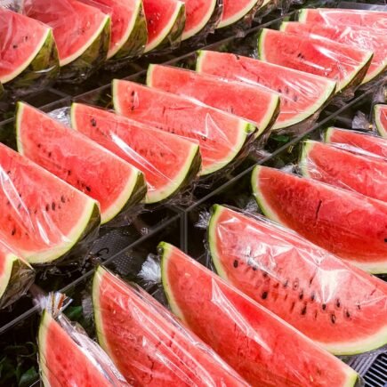 sliced watermelon on stainless steel tray