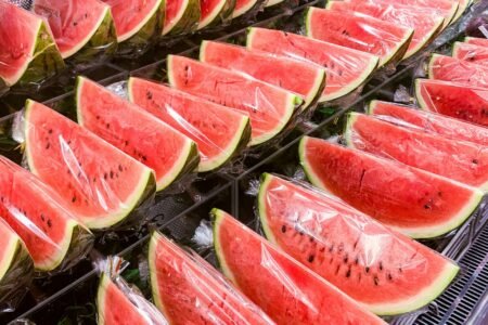 sliced watermelon on stainless steel tray
