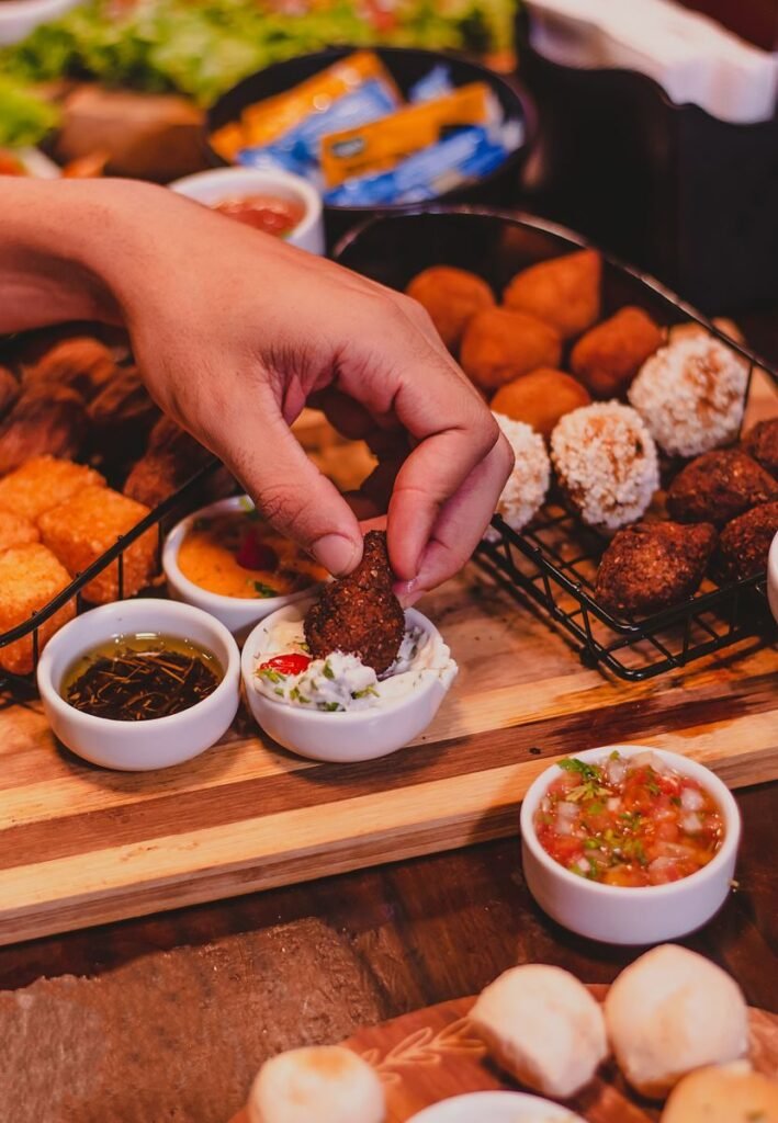 Imagem atual: Savor homemade meatballs with a variety of dipping sauces for a flavorful snack.